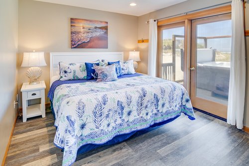 This bedroom with a comfy king has an ocean view.
