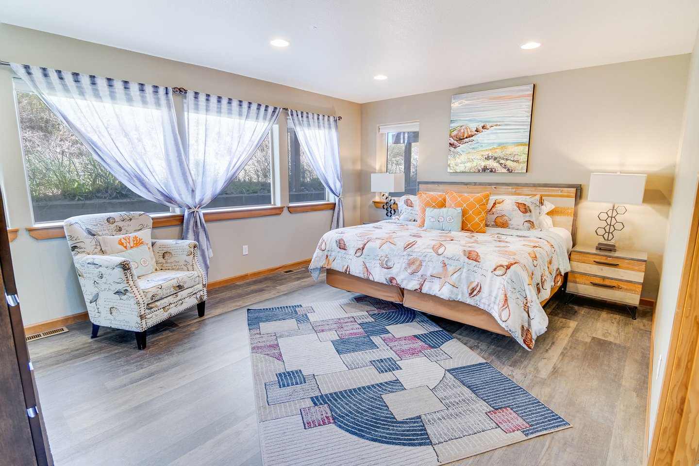This large bedroom with king bed  is on the entry level floor of this home.