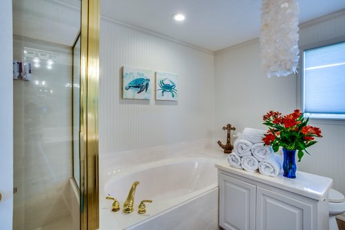 Walk in shower and soaking tub in this spacious bathroom.