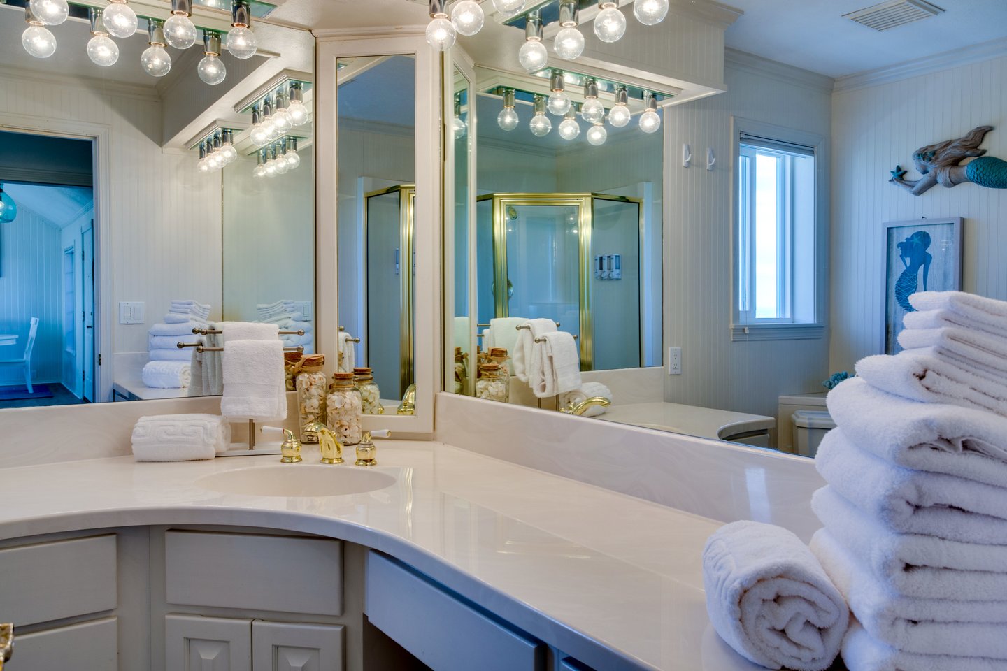 The second bath is next to the kitchen and the bedroom with the queen bed.