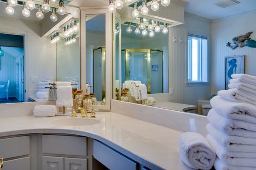 The second bath is next to the kitchen and the bedroom with the queen bed.
