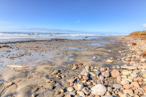 Miles of sandy beach to walk both north and south. Winter time brings out some additional rocks!