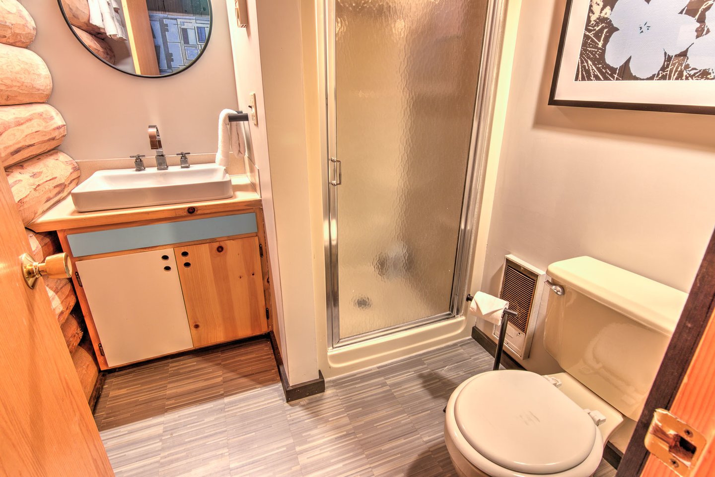 Another bathroom can be found at the end of the hallway with a walk in shower.