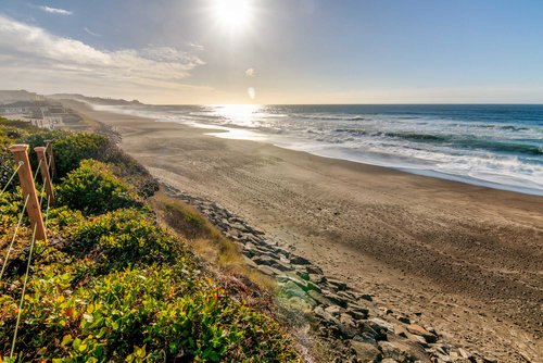 Beach to the south, with rock formations.