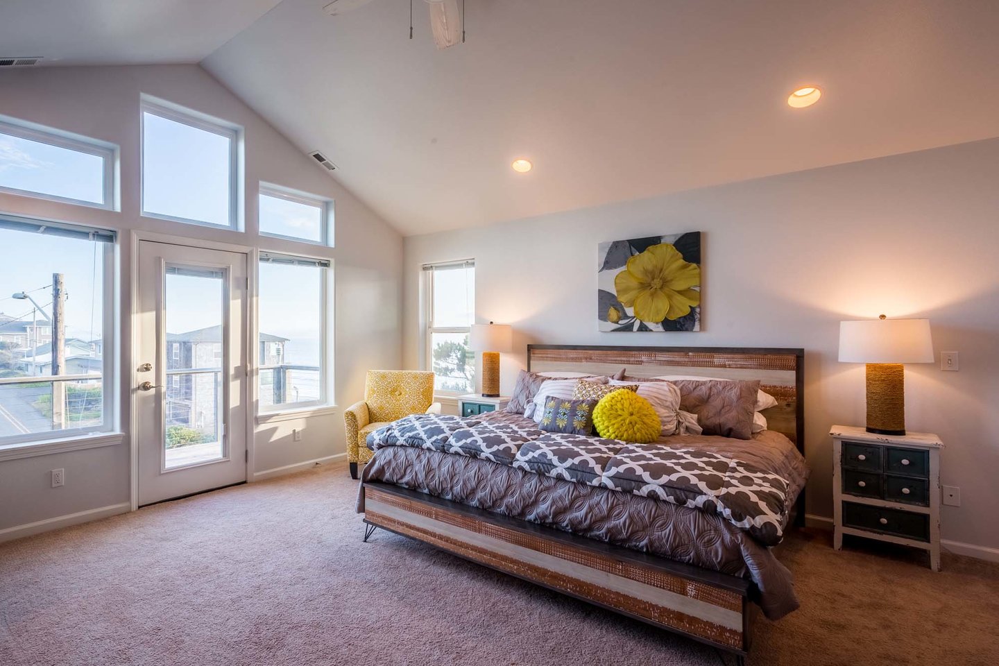 The spacious primary bedroom with king bed has its own private balcony.