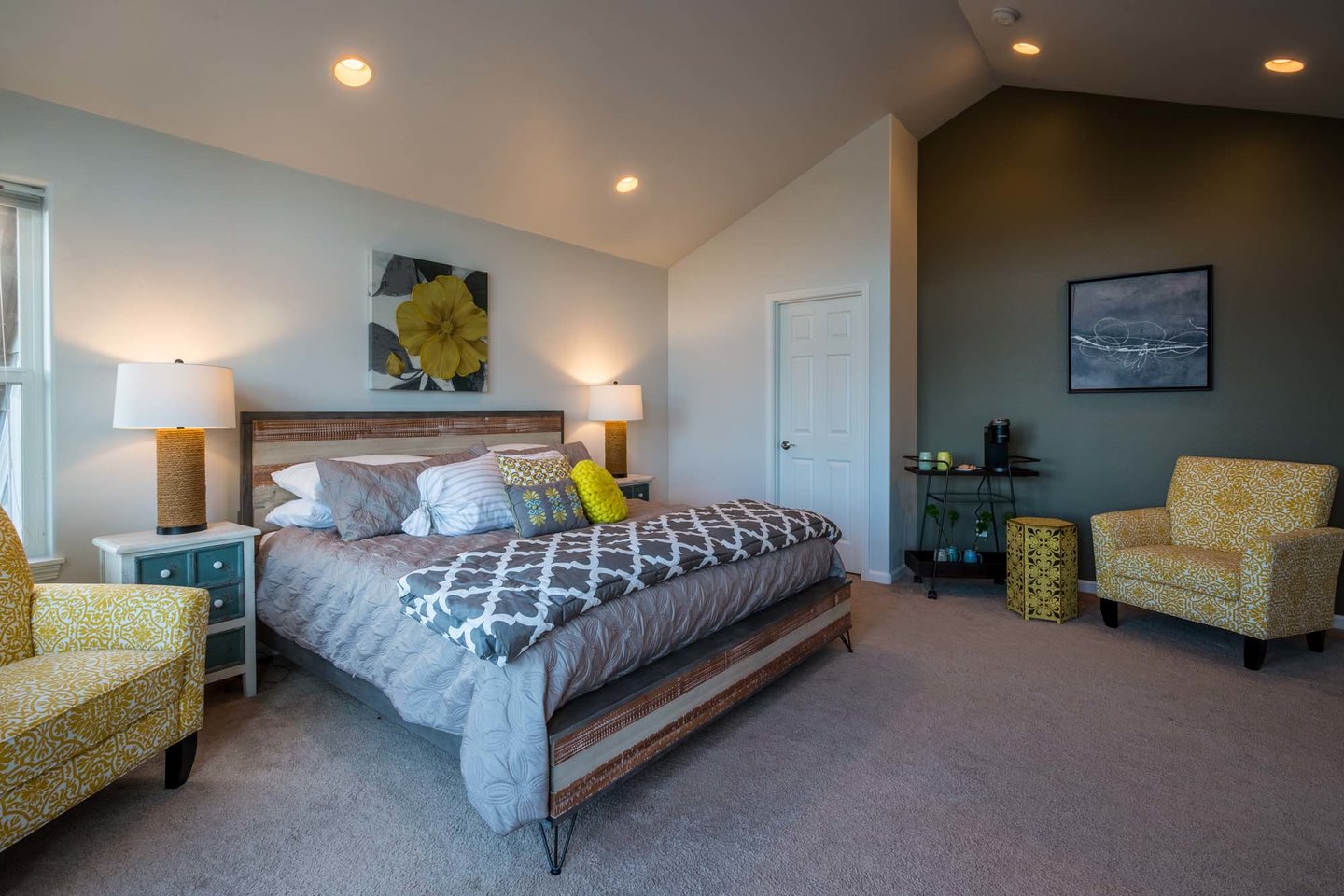 Snuggle up in the primary bedroom while enjoying a cup of coffee from your own in room Keurig.