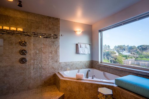 The primary ensuite walk in shower has 6 shower heads!
