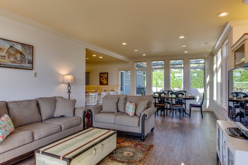 The great room is open and sunny, perfect for a gathering of friends and family.