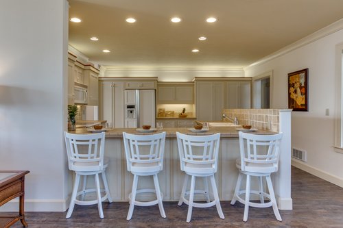 Comfy bar stools invite you to chat and watch the cook in the kitchen!