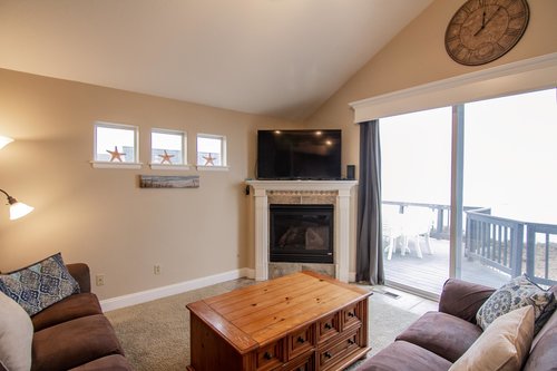 Cozy up in the living room with a fireplace and wonderful ocean views!