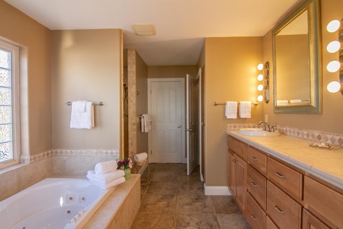 The larger primary bathroom with a double vanity is very relaxing.
