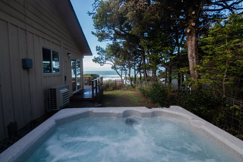 Enjoy the hot tub while listening to the ocean waves.