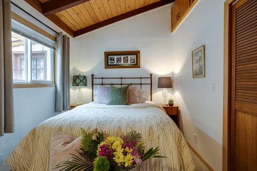 A cozy bedroom on the main floor with a queen bed.