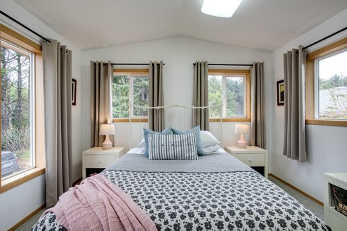 Windows in the upstairs bedroom looking out into the beautiful greenery.