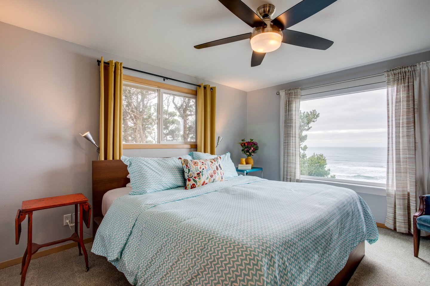 The bright and airy primary bedroom upstairs has fantastic ocean views.