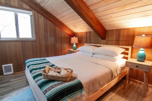 Enjoy a unique bedroom upstairs with a queen bed.