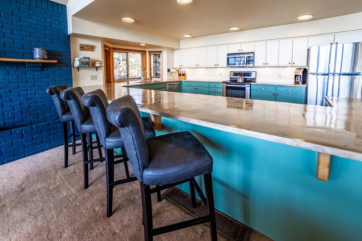 The spacious kitchen with bar seating is great to cook dinner together.