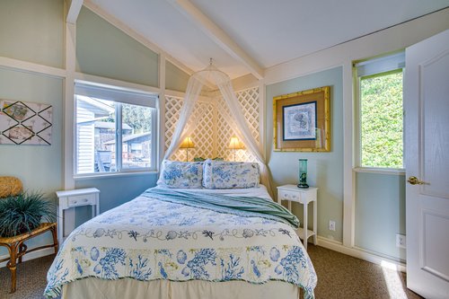 The canopy in the queen bedroom upstairs adds a bit of  whimsey.