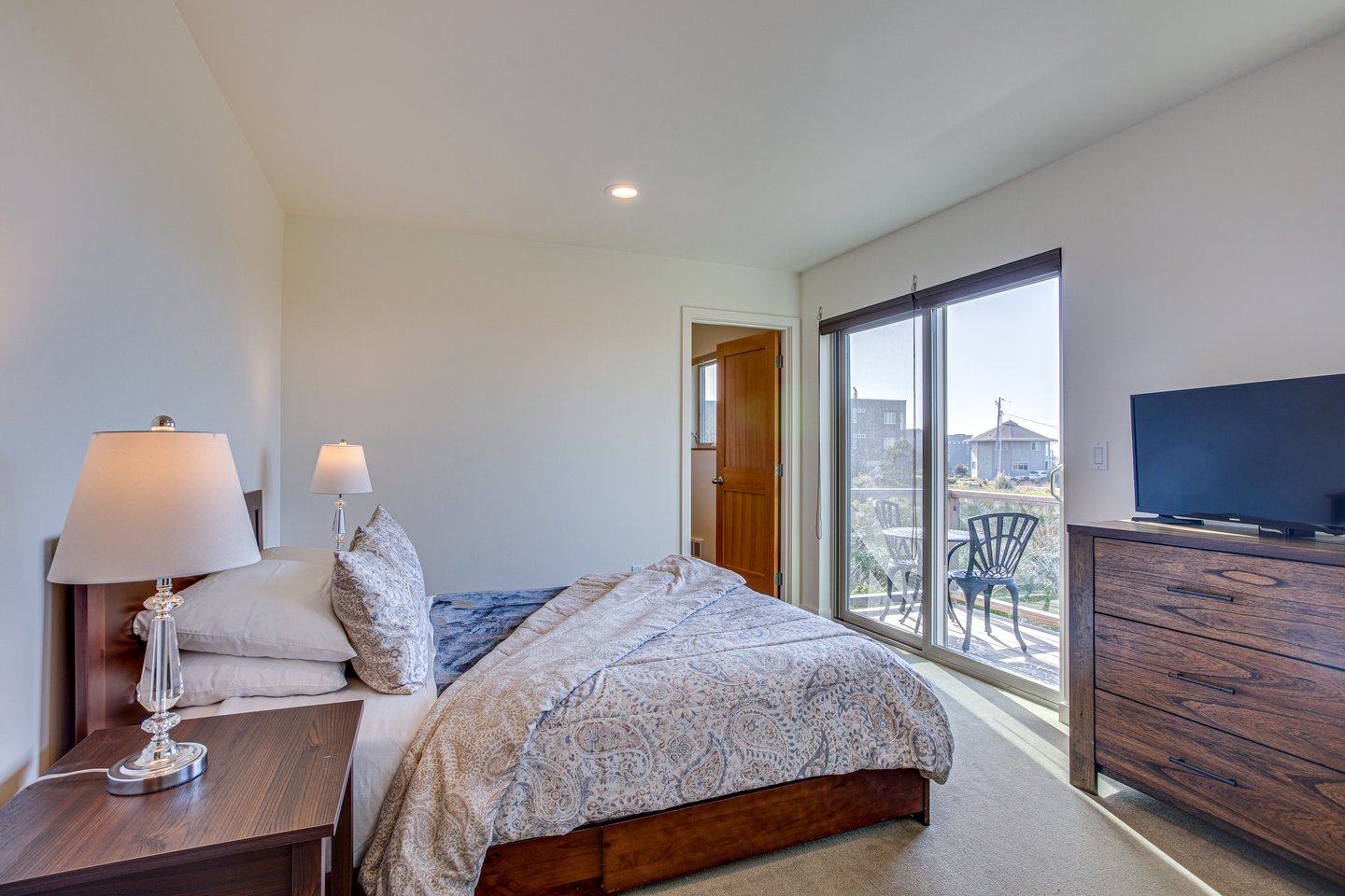 Cozy up in the queen bedroom with ocean views downstairs.