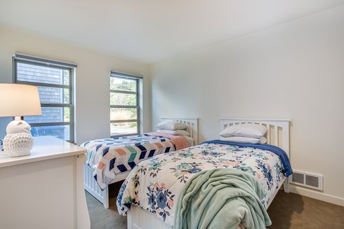 A cozy and colorful downstairs bedroom with two twins.
