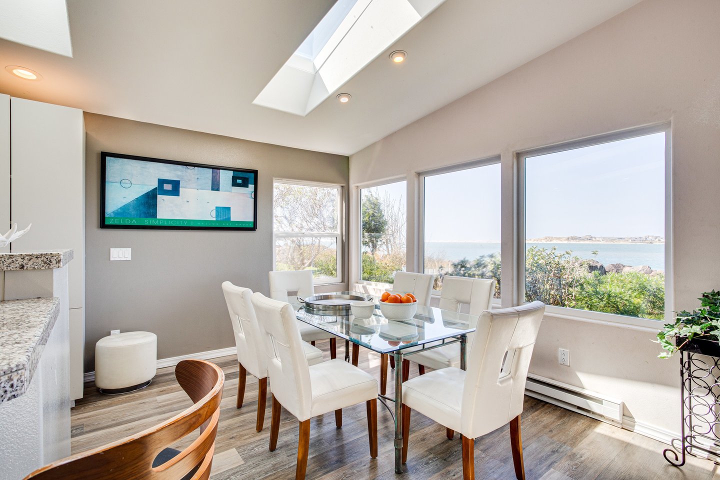 A large dining table with a view of the bay.