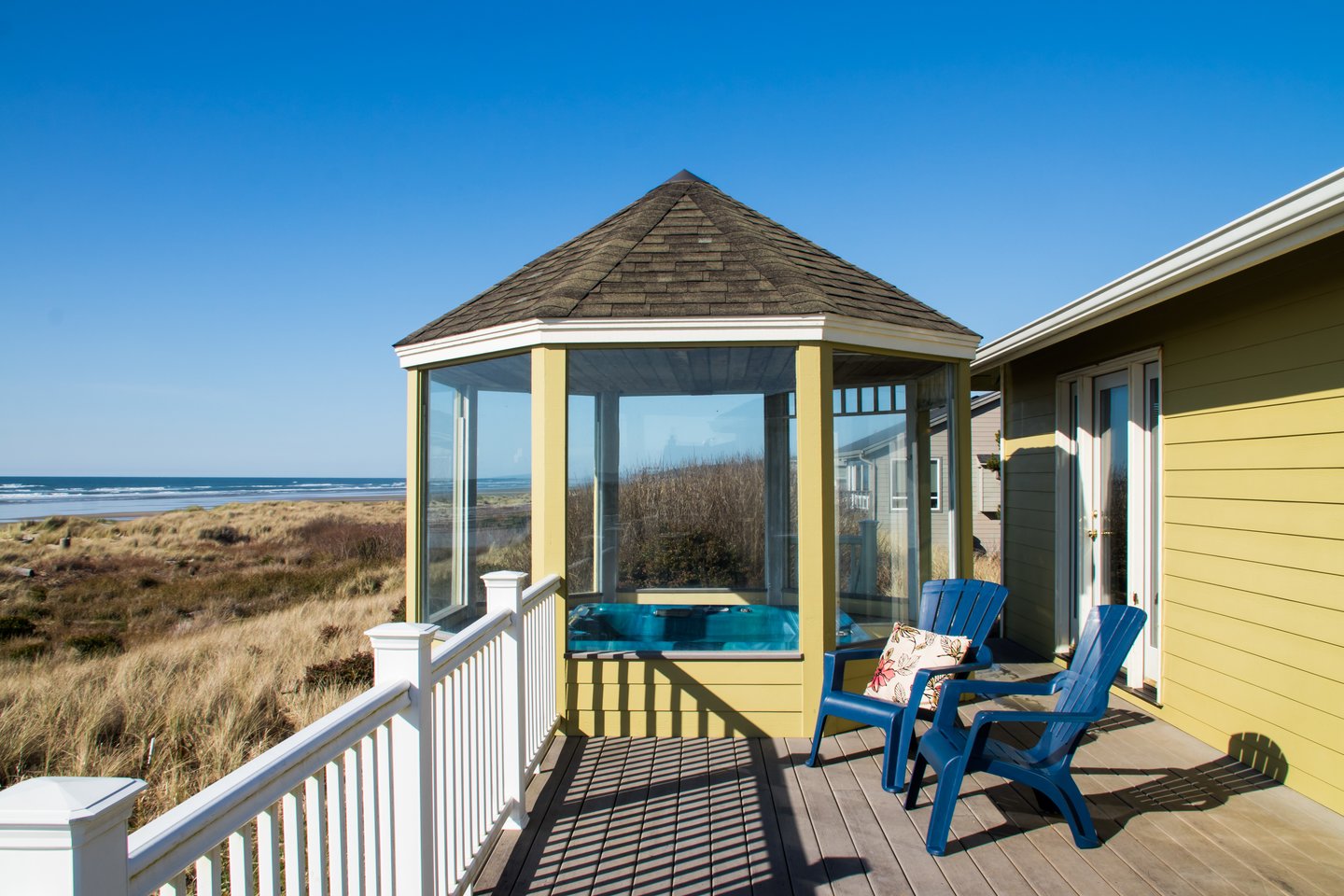 Relax on the deck while the kids play in the sand.