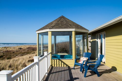 Relax on the deck while the kids play in the sand.
