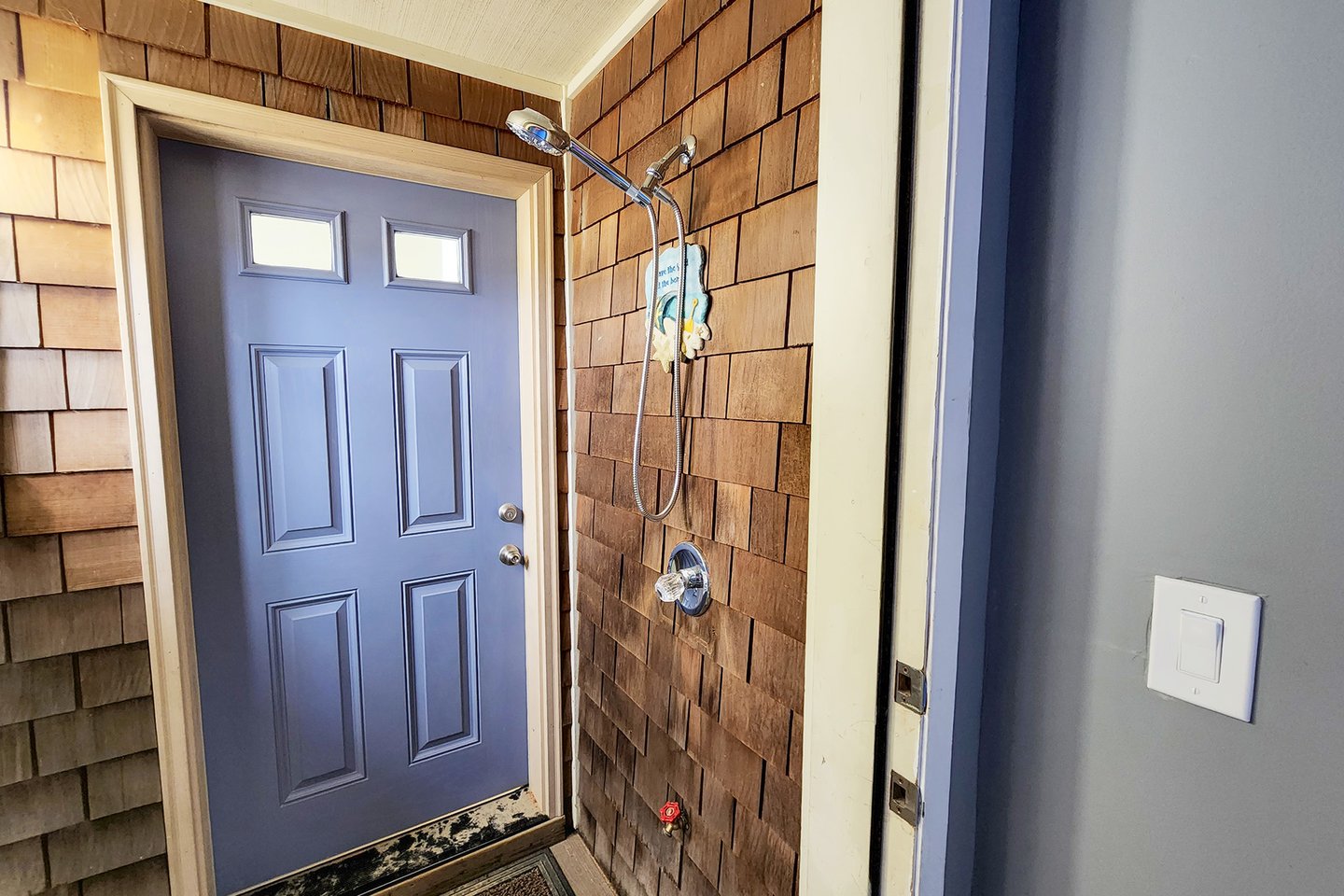 The outdoor shower is perfect to rinse off after a day at the beach.