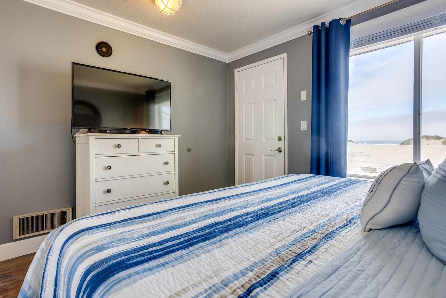 Primary bedroom with beach access and ocean views.