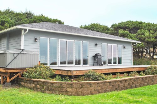 Sandy Seclusion boasts a large deck, hot tub and BBQ grill- all with ocean view.