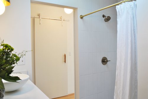 Large walk in tiled shower with a huge closet across the hall.