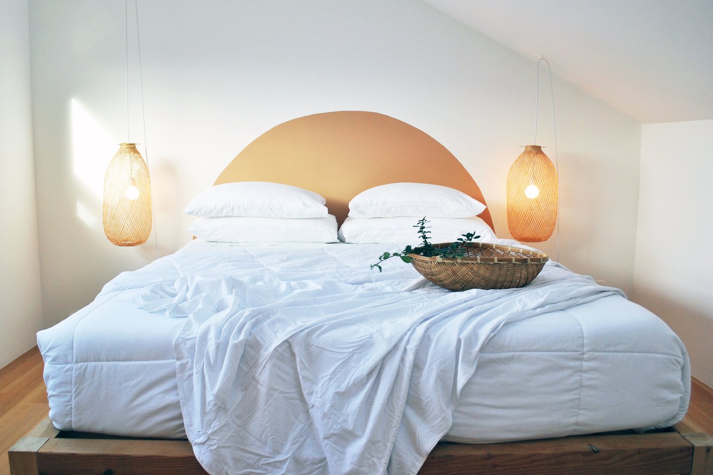 Calming palette and minimalist primary bedroom with king bed.