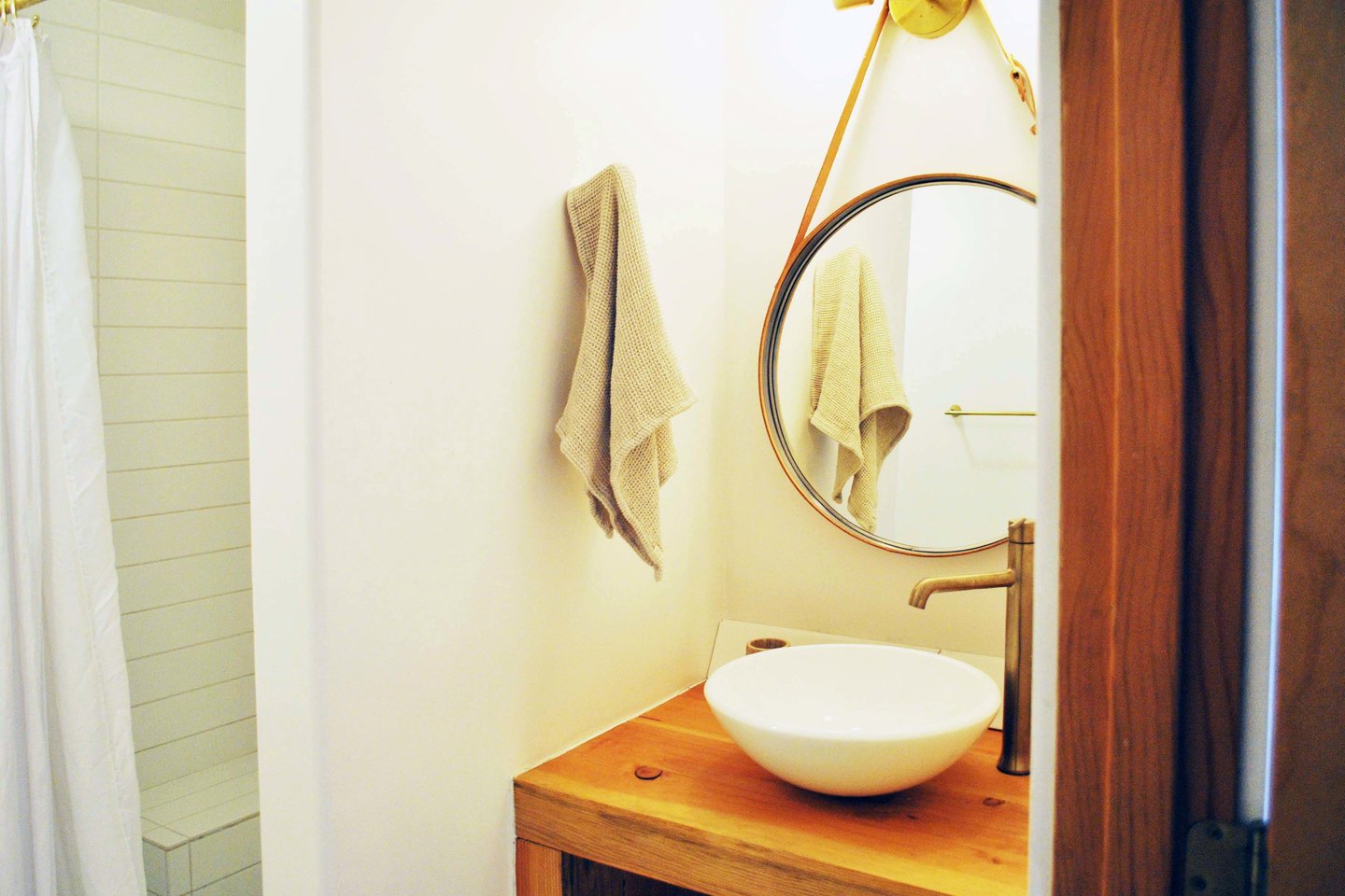 Tiled walk in shower and vessel sink bath.