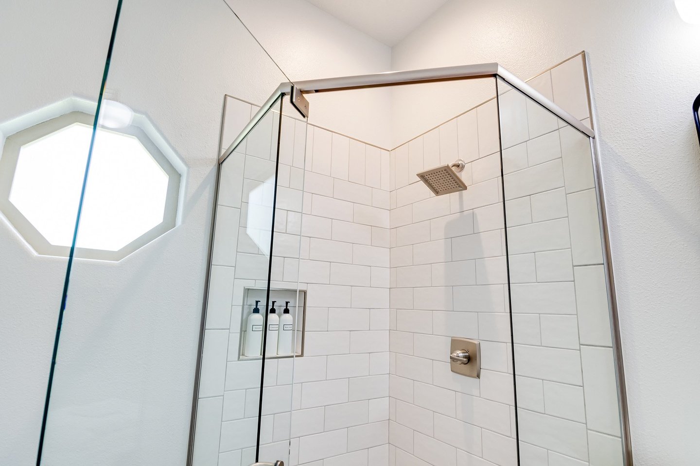 The bath in the hallway has a walk-in shower.