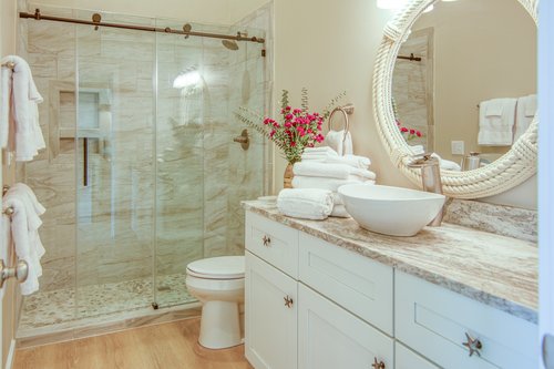 Beautiful tiled walk in shower and large vanity.