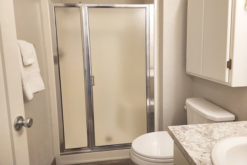 A full bath in the hallway adds some extra privacy.