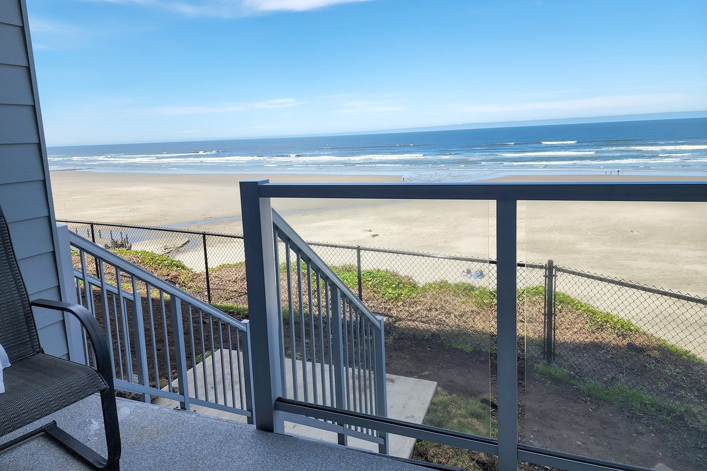 Stairs take you down off of the deck to a small grassy area.