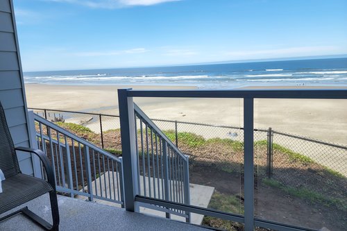Stairs take you down off of the deck to a small grassy area.