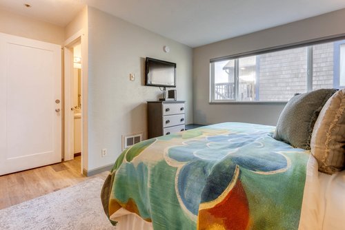 An ensuite bath plus television adds to the appeal of this bedroom.