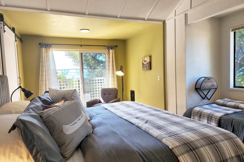 The king bed is comfortable in this large upstairs bedroom.