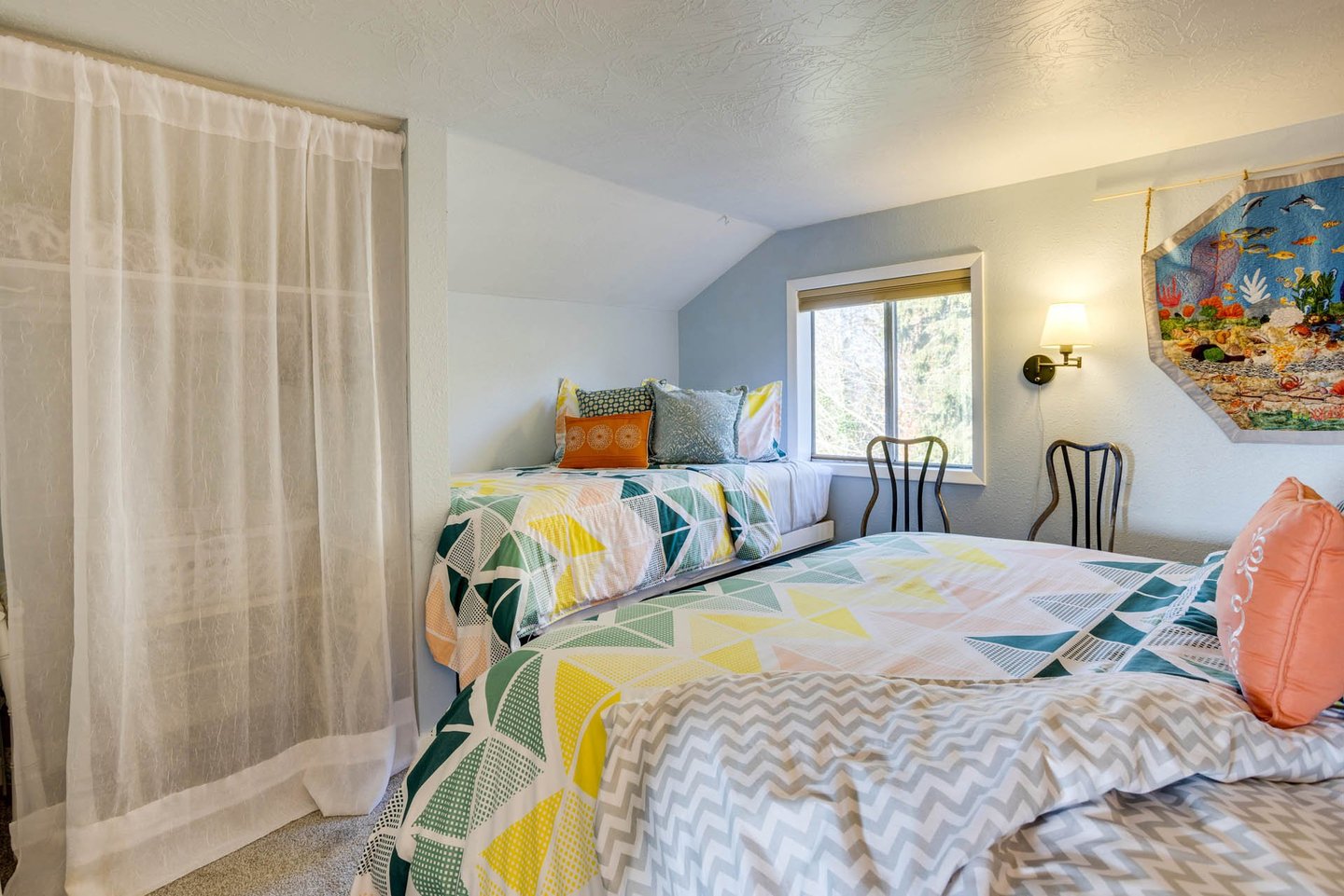 This bedroom has a queen bed and a twin for added sleeping space.
