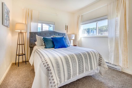 Cozy queen bed in one of the bedrooms.