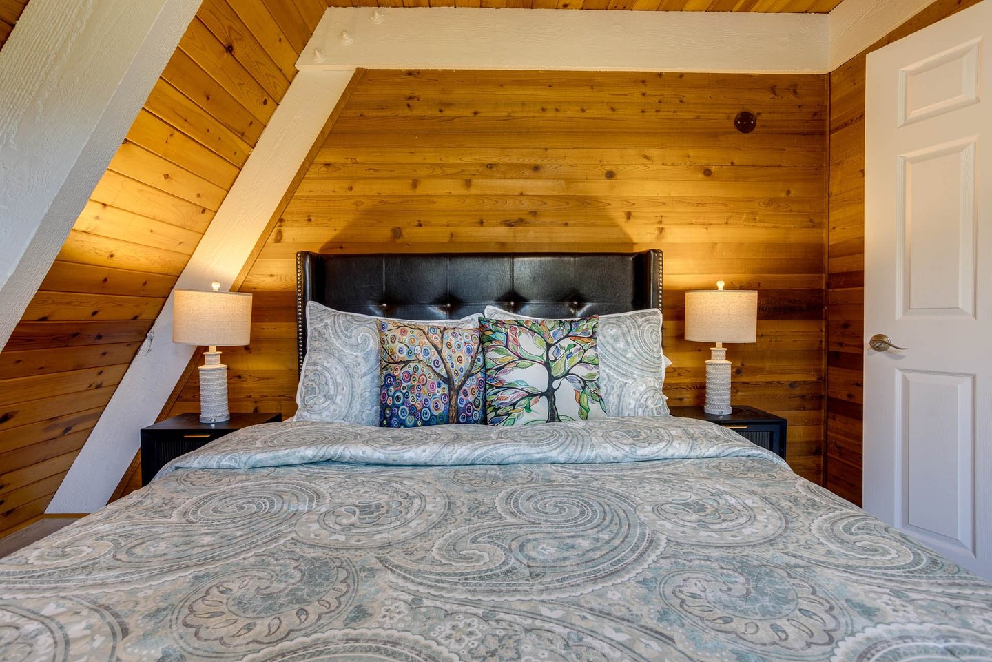 Get a great nights sleep in this woodsy A Frame bedroom.