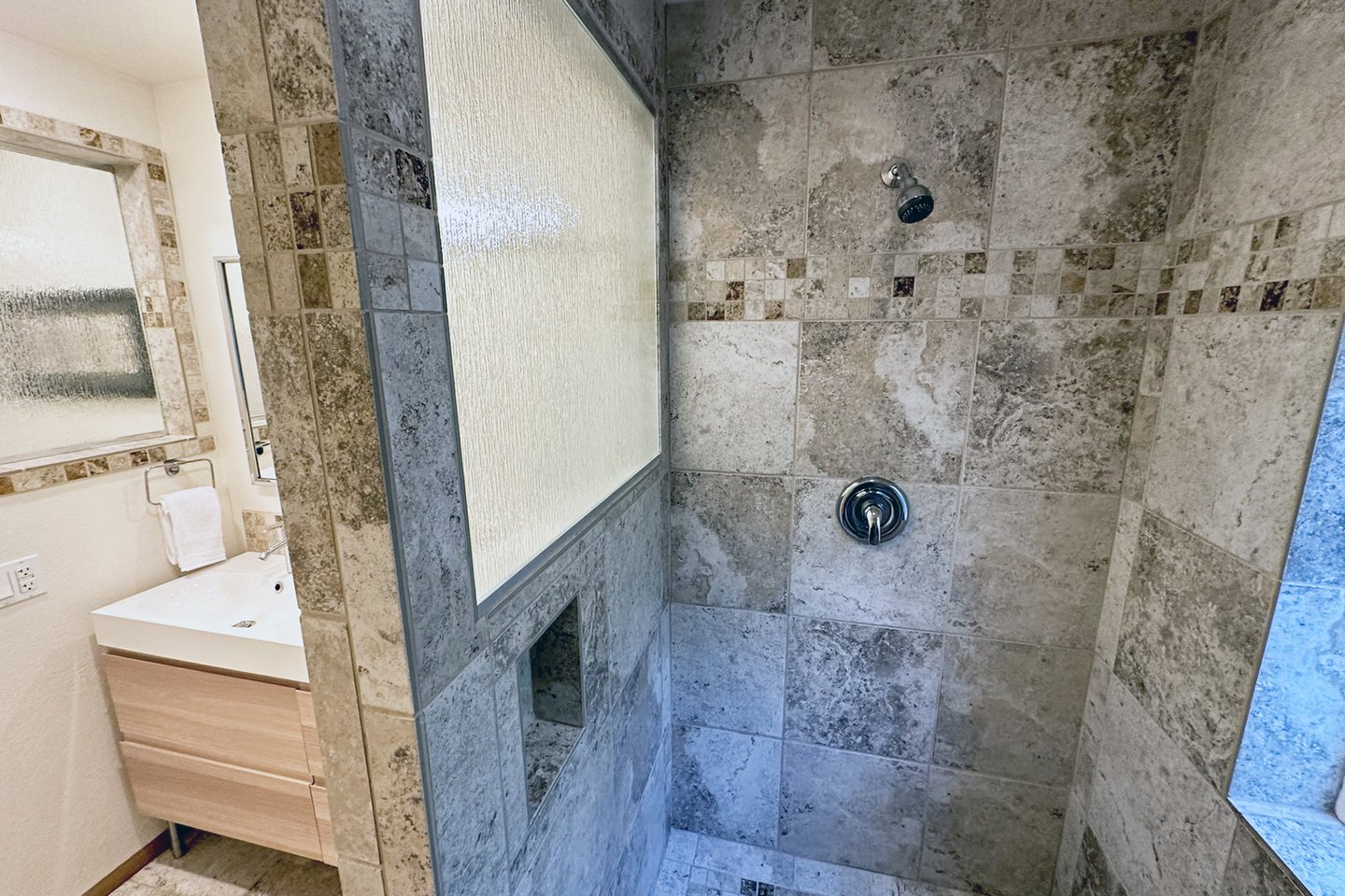 Walk in tiled shower.