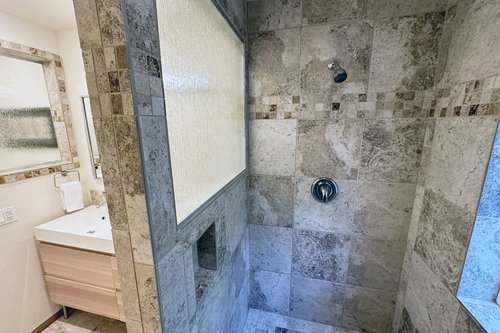 Walk in tiled shower.