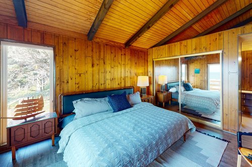 One of the bedrooms with an ensuite bath and king bed.