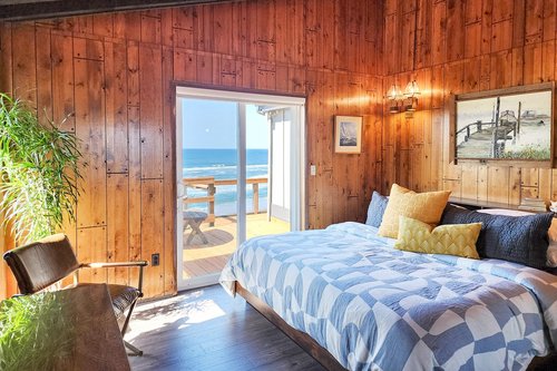 A second bedroom on the main floor has access to the deck and ocean views.