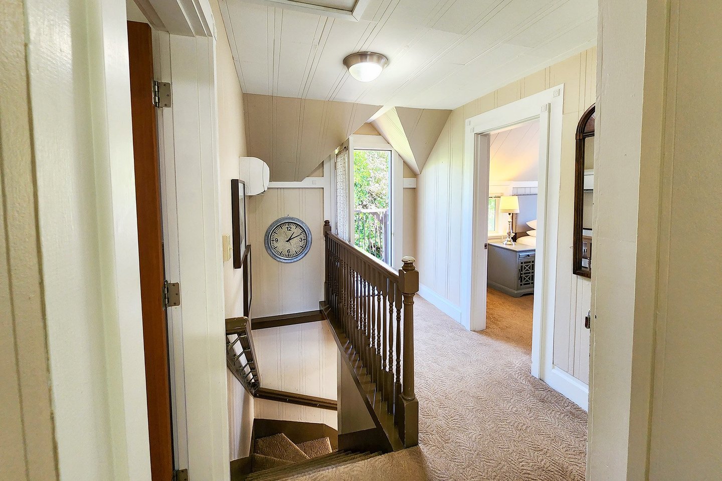 Up the stairs is a hallway with a door to a small balcony to let in fresh salt air.