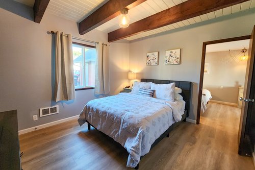 Second bedroom with Queen bed and connection to another bedroom.