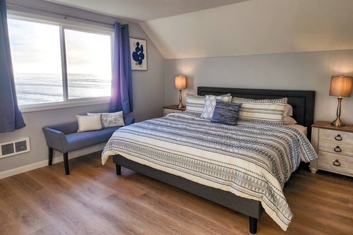 Primary bedroom upstairs with King bed and ocean views!